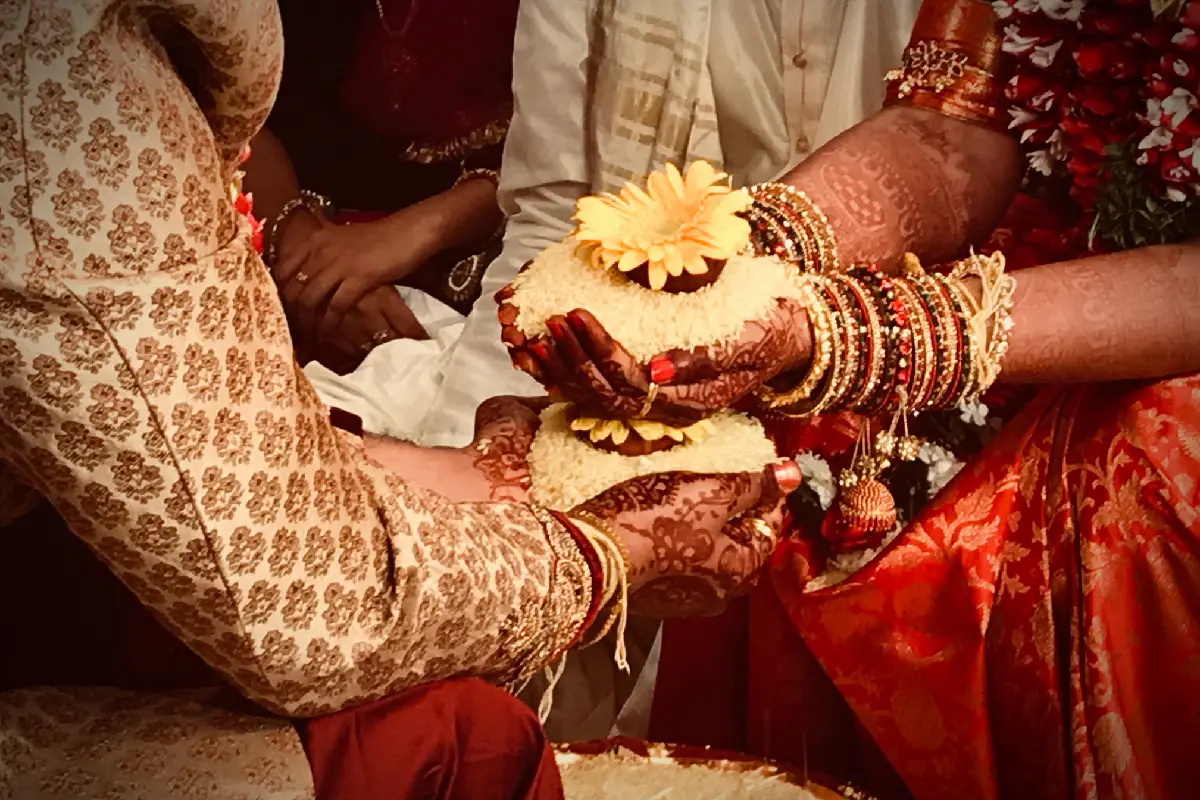 Wedding ritual with rice and flowers in April marriage muhurat.