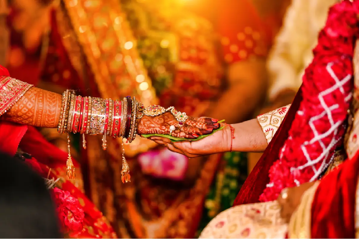 Henna-adorned hands in June marriage muhurat