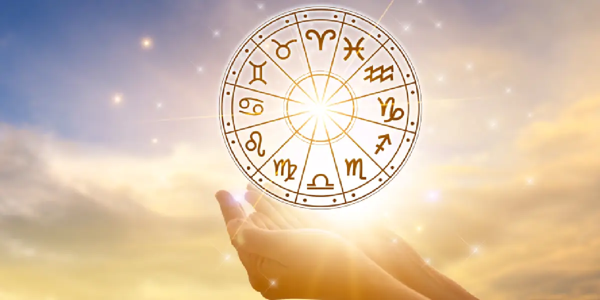 Golden zodiac wheel featuring all 12 astrological signs, glowing against a serene sky, symbolizing the cosmic energy and insights of horoscope predictions for 2025