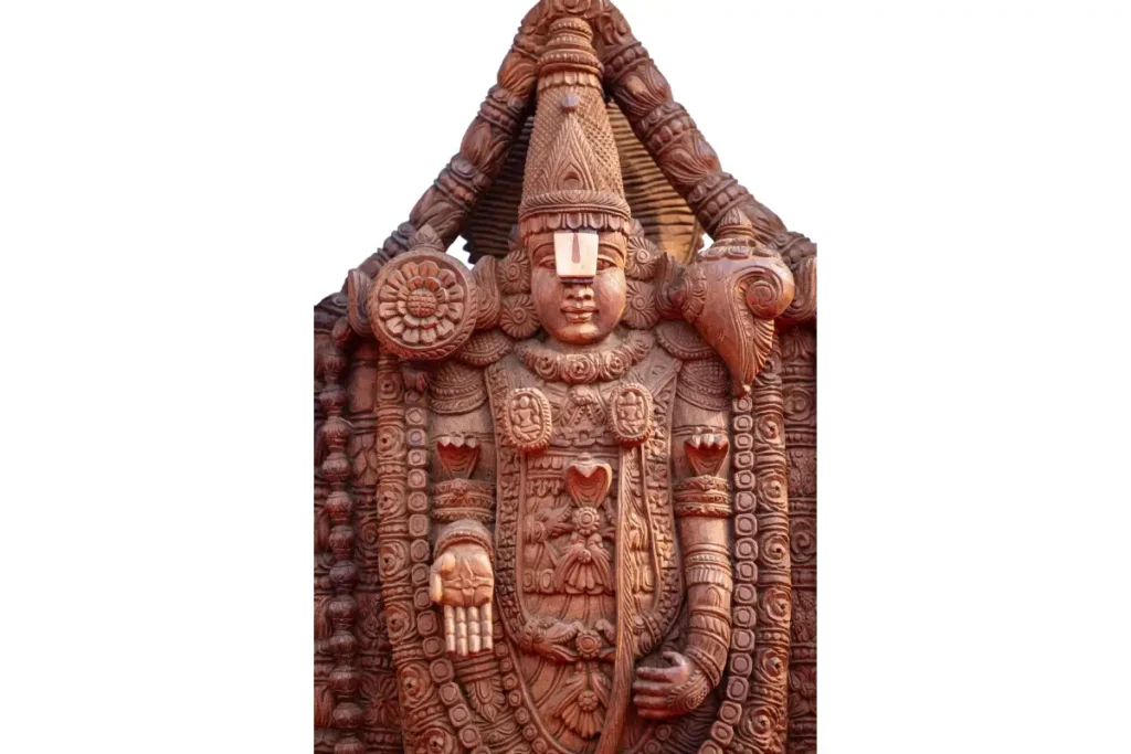 Intricate wooden sculpture of Lord Balaji adorned with traditional carvings, representing divine grace and blessings